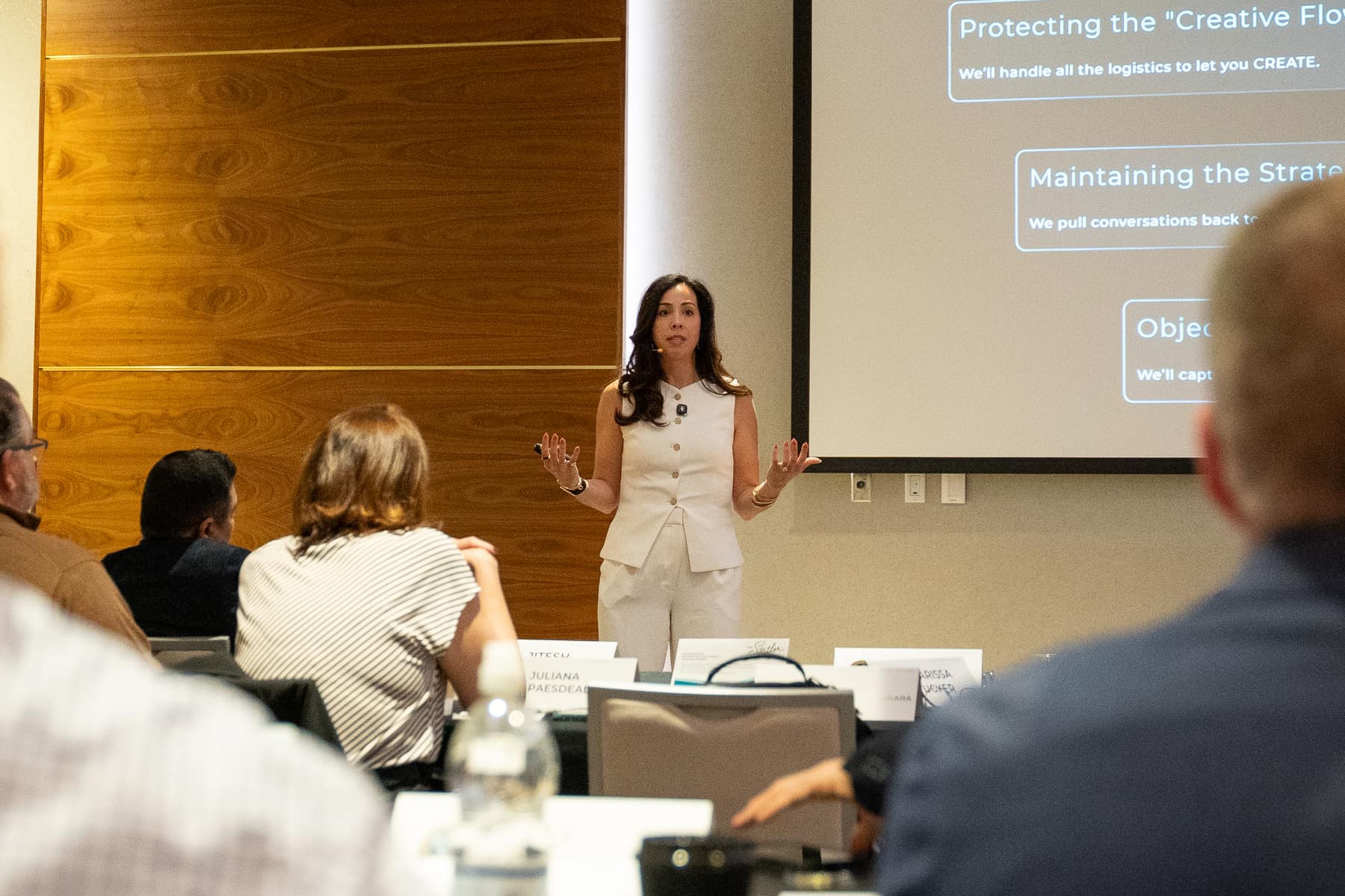 Brittany Tipton teaching a room of leaders in front of a presentation screen