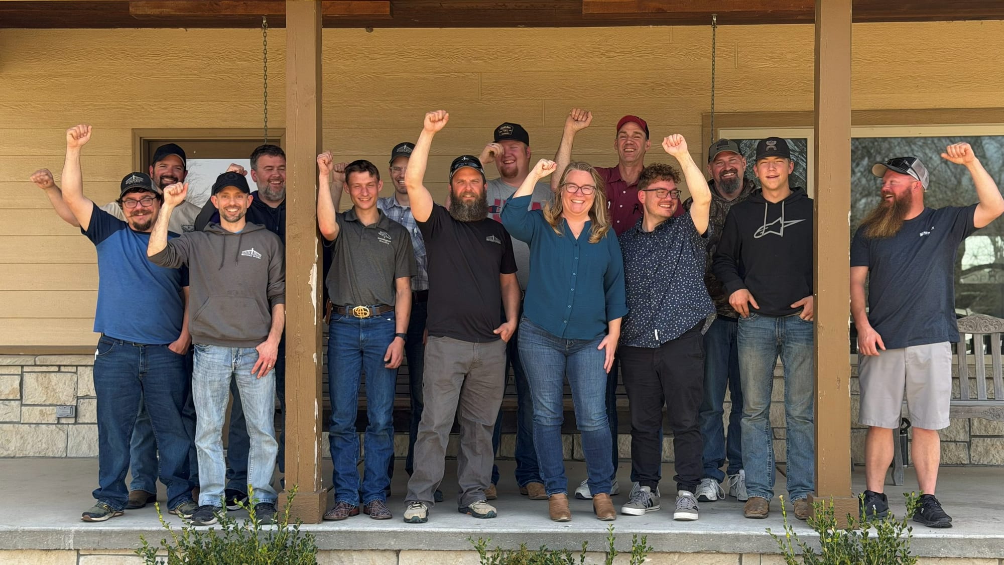 A steel manufacturing team celebrating on the porch at the end of their retreat