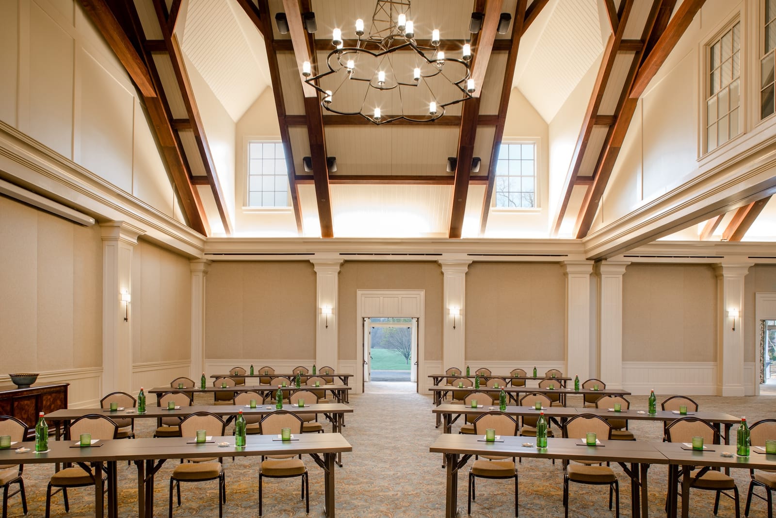 A ballroom with vaulted ceilings set classroom style for a meeting