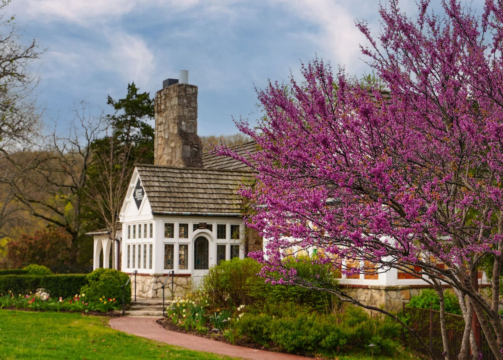 The historic Worman House in spring with redbud in bloom