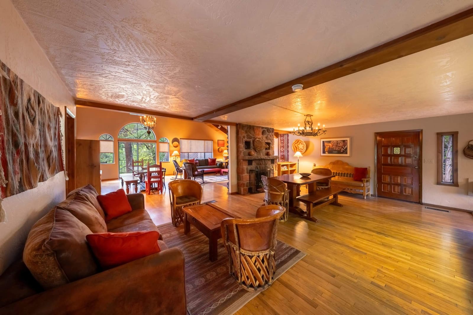 Ponderosa great room with stone fireplace, sofas and dining tables
