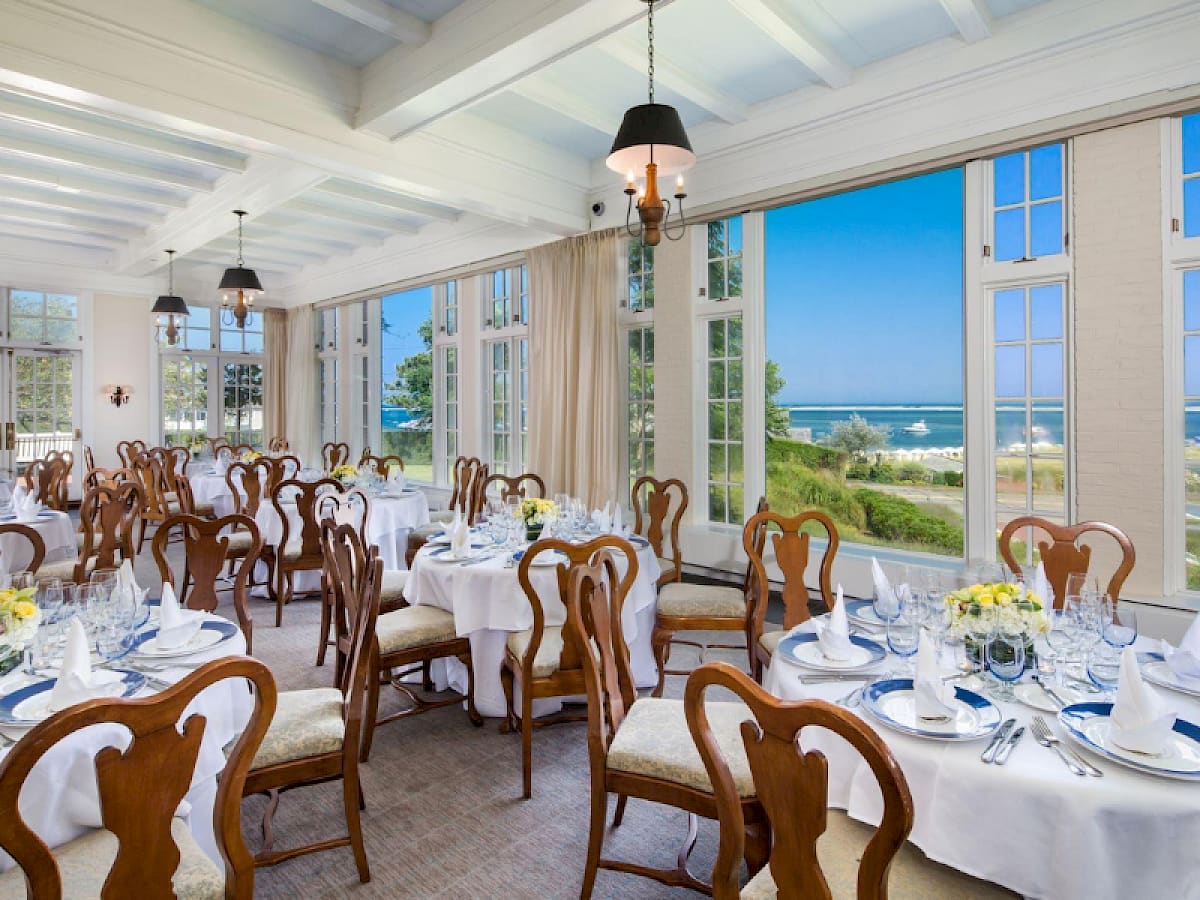 Harbor View Room set for dinner with tall windows facing the water