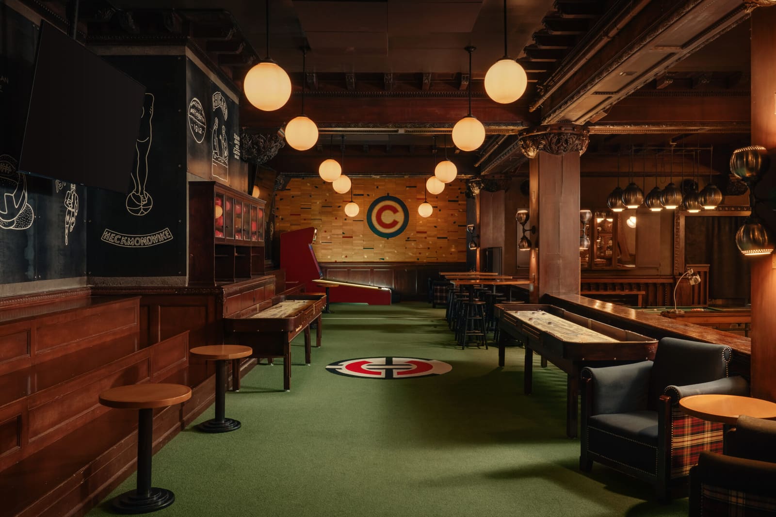 The Game Room with shuffleboard tables and a wood-paneled bar