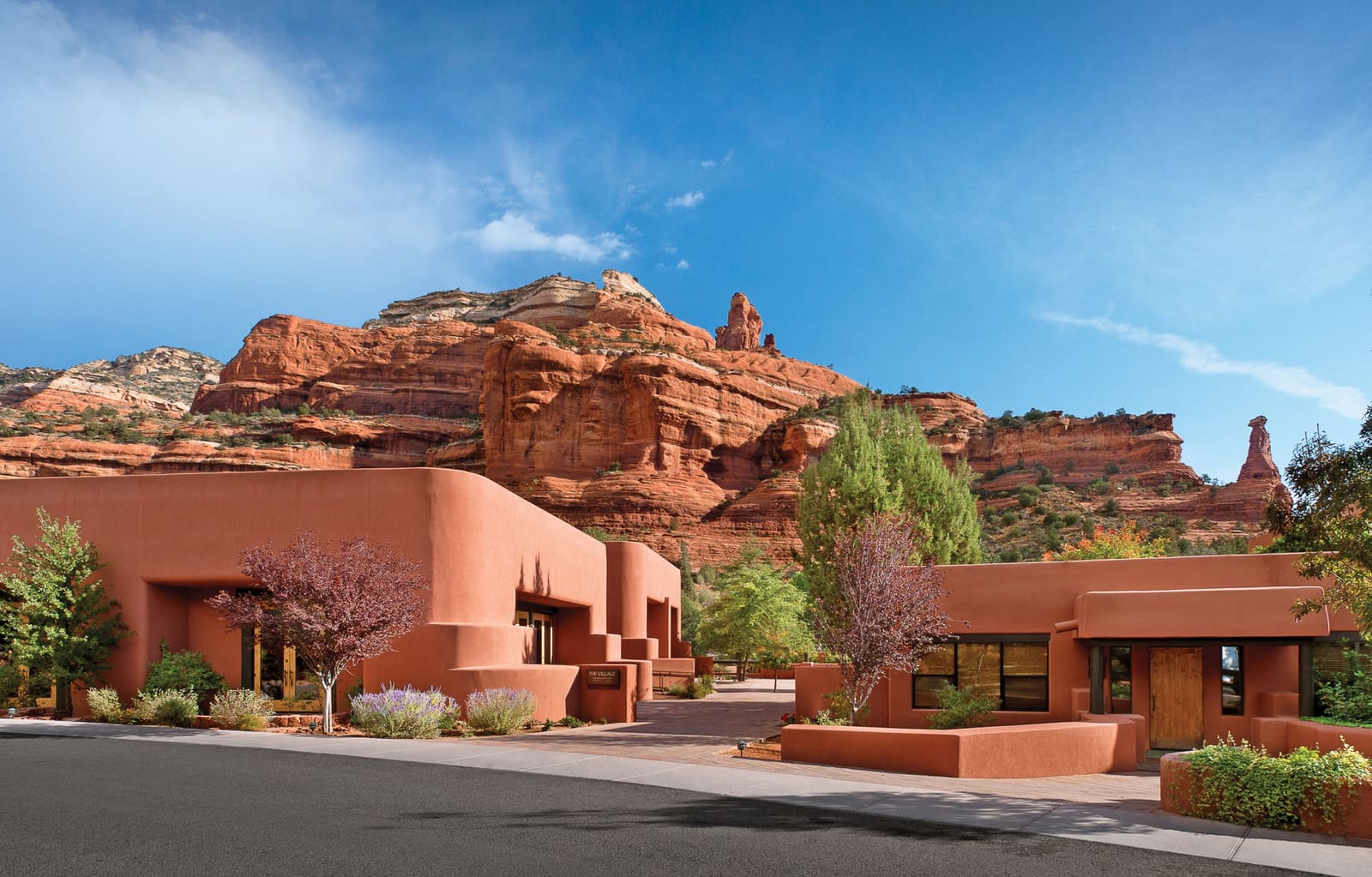 Adobe Meeting Village buildings below red rock cliffs in Boynton Canyon