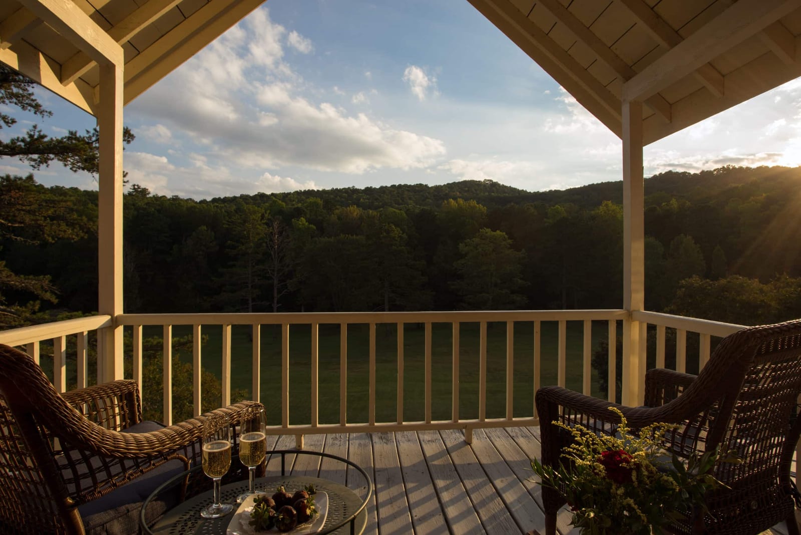 A covered porch looking out over wooded mountains