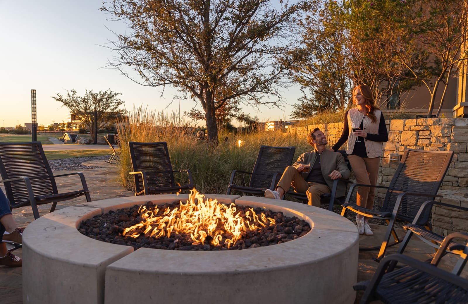Guests around an outdoor firepit at golden hour