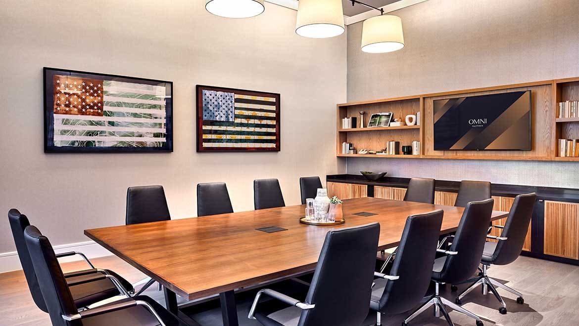 Boardroom with a wood conference table for 12 and a wall screen