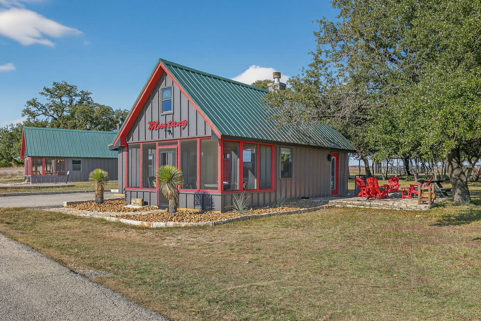 Private cabins with screened porches and a firepit patio under live oaks