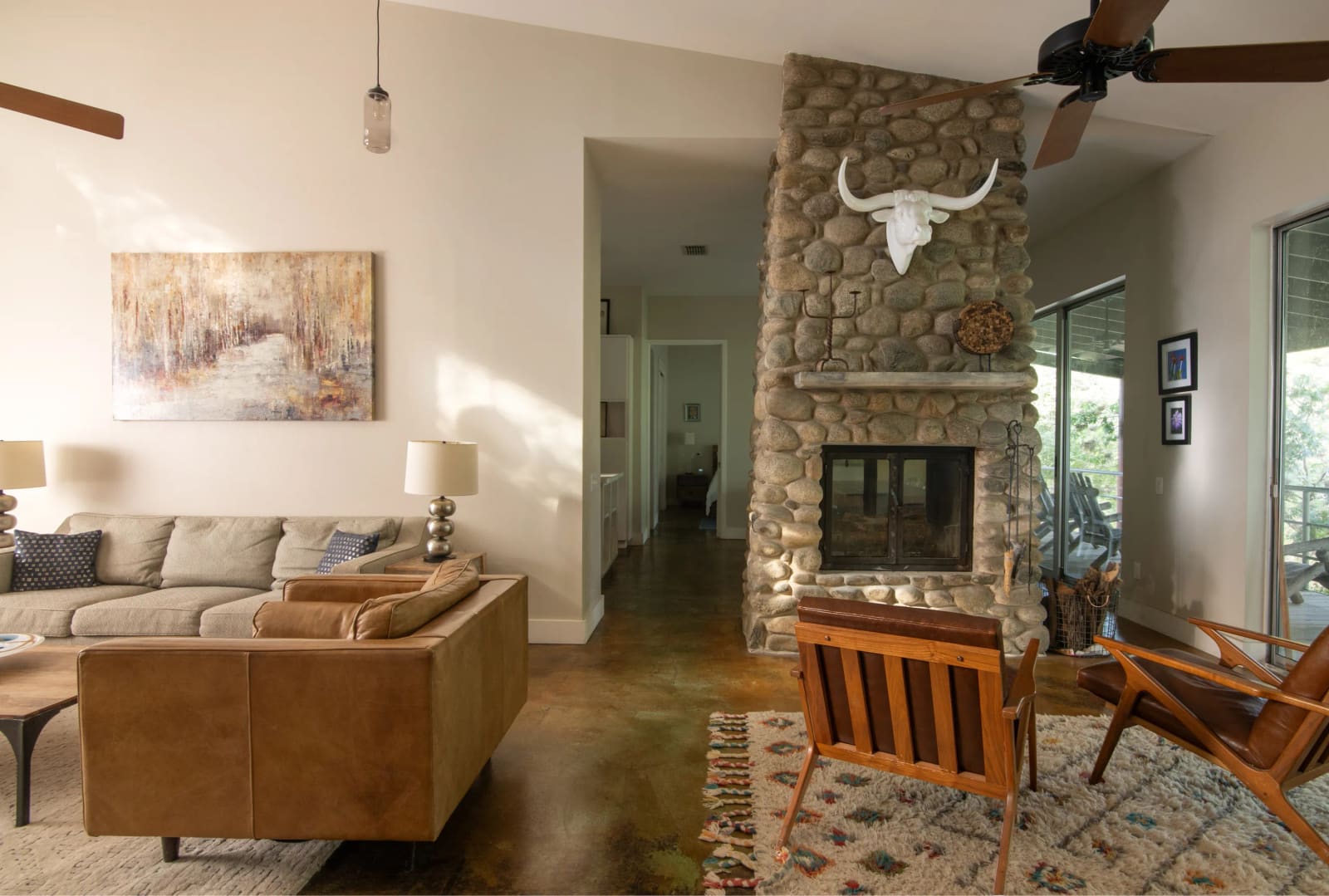 Living room with a stone fireplace in one of the guest homes