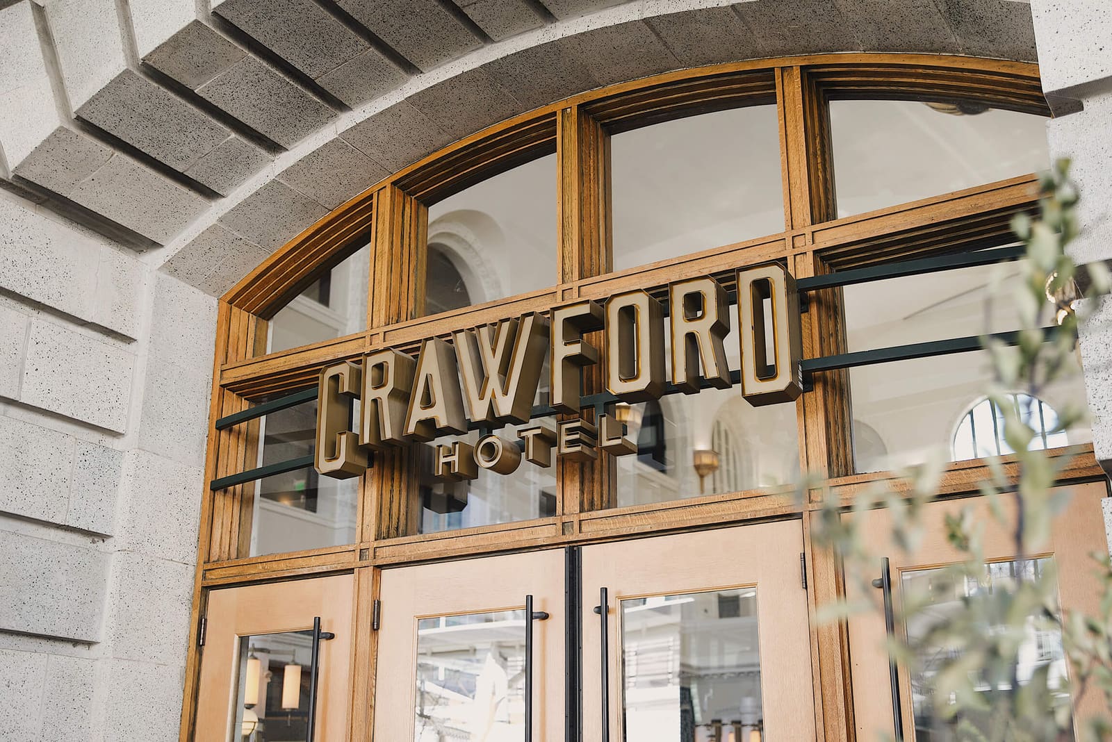Crawford Hotel sign over the arched wood entrance of Union Station