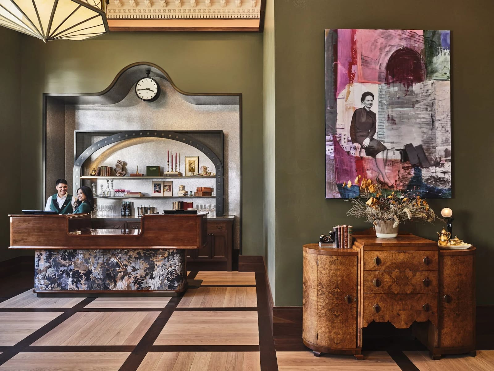 Hotel front desk with vintage wood furniture and a station clock