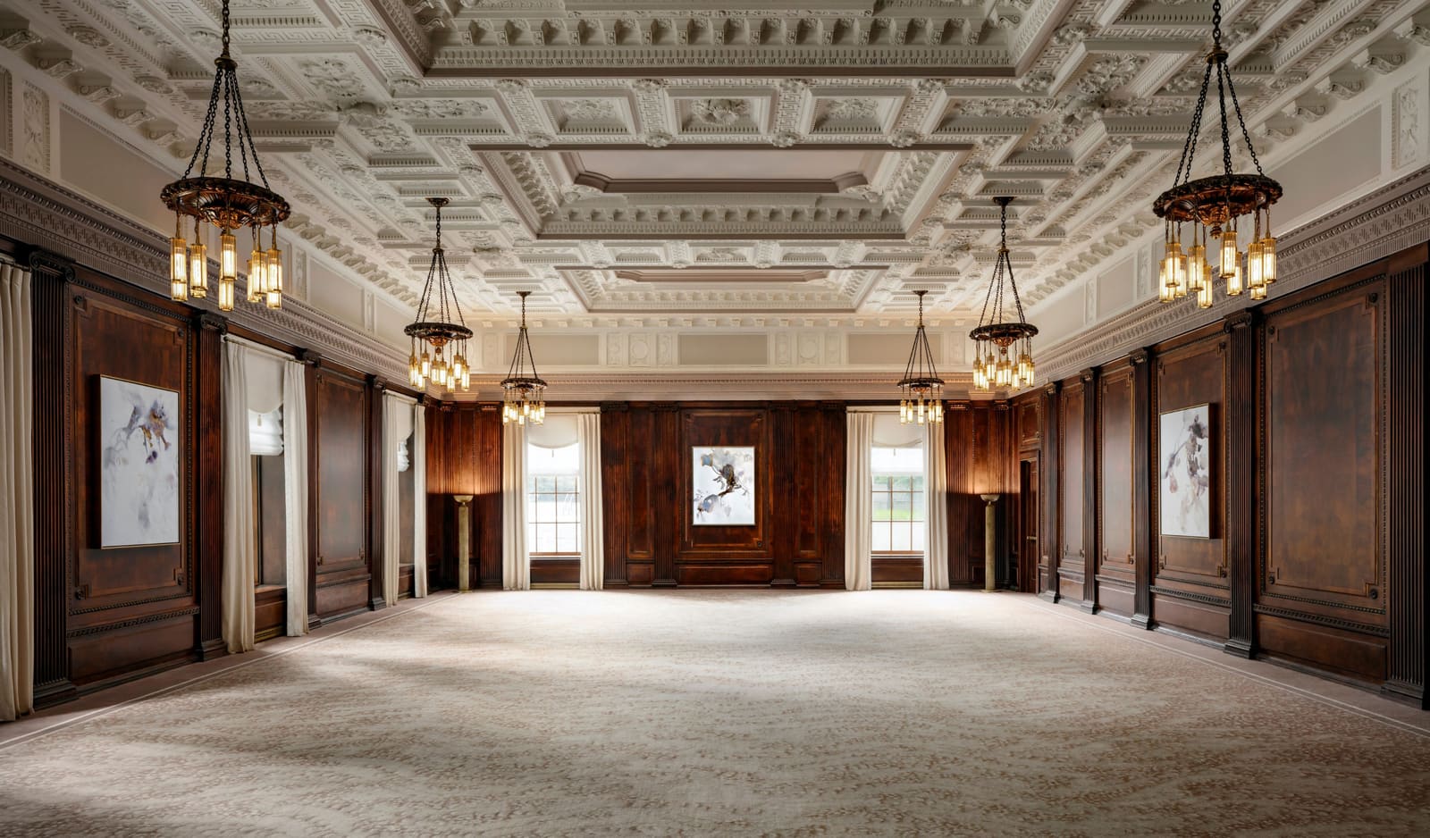 The Grand Ballroom with plaster ceiling, walnut paneling and chandeliers
