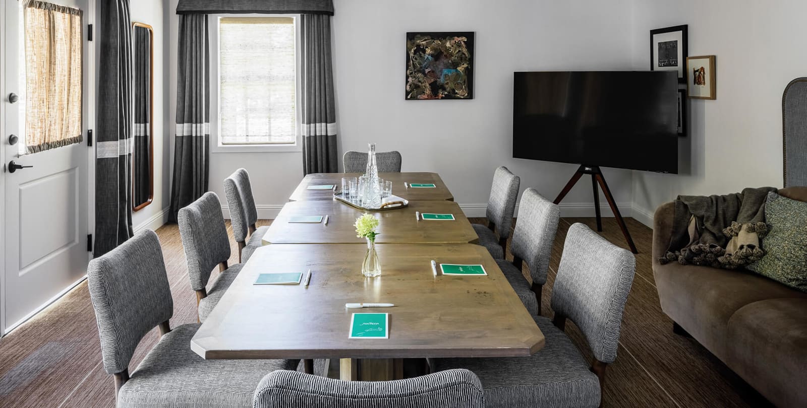 The Board Room set with a conference table and screen