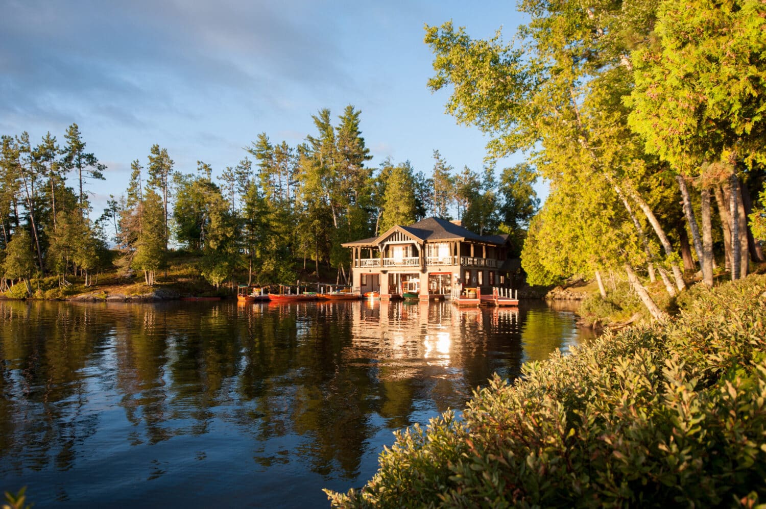 The Point's boathouse on Upper Saranac Lake in evening light