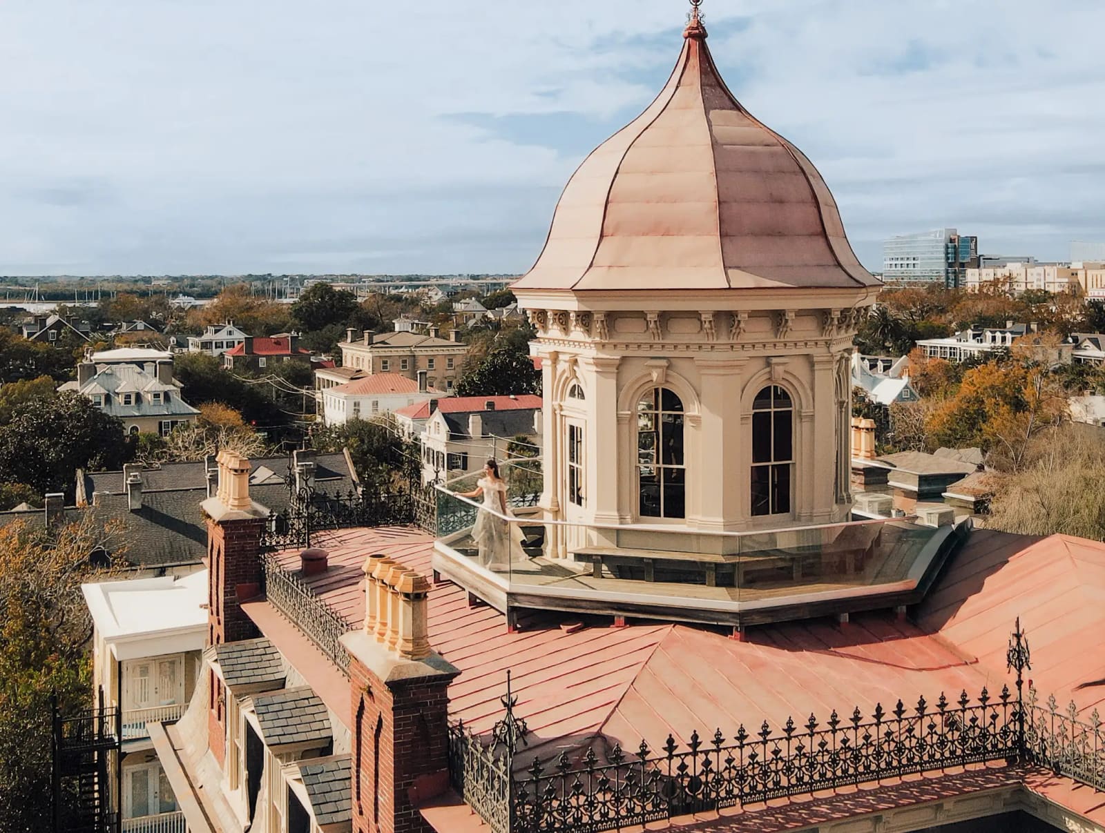 The mansion's copper-domed rooftop cupola above downtown Charleston rooftops