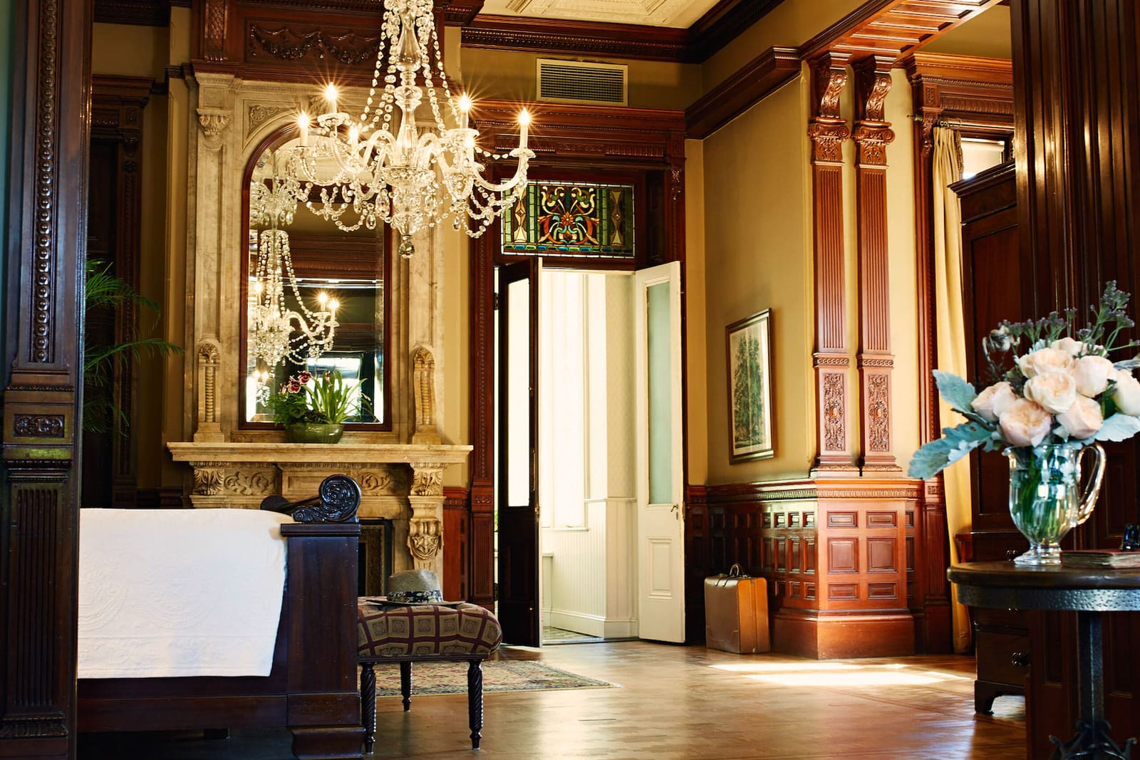 Grand Mansion Suite with crystal chandelier, carved woodwork and a marble fireplace